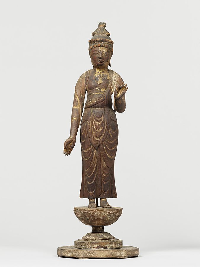 Piccola statua lignea di bodhisattva in piedi su un loto, con resti di doratura