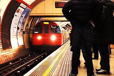 Piattaforma della metropolitana di Londra e treno in arrivo.