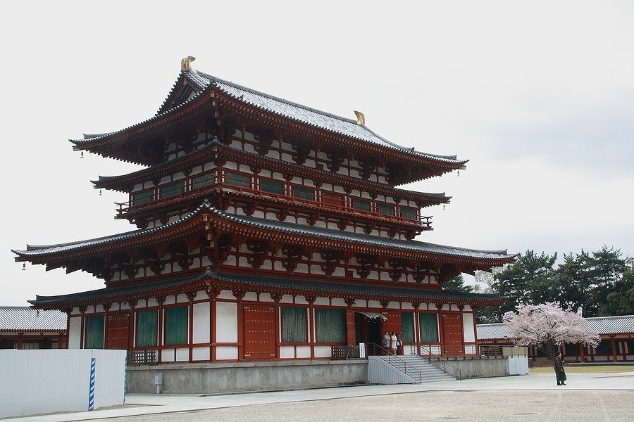 Il tempio Yakushi-ji a Nara, circondato da fiori di ciliegio.