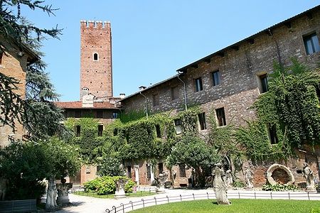Cortile del Castello di Romeo a Montecchio Maggiore con statue e mura coperte di edera.
