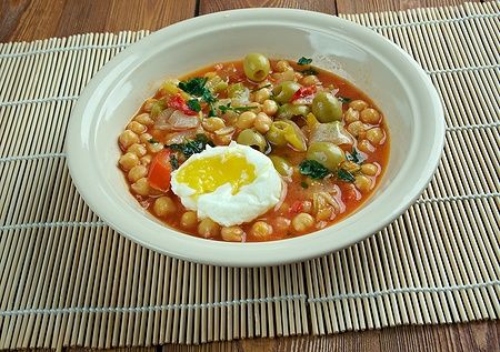 Zuppa tunisina lablabi con ceci, uovo morbido e condimenti.
