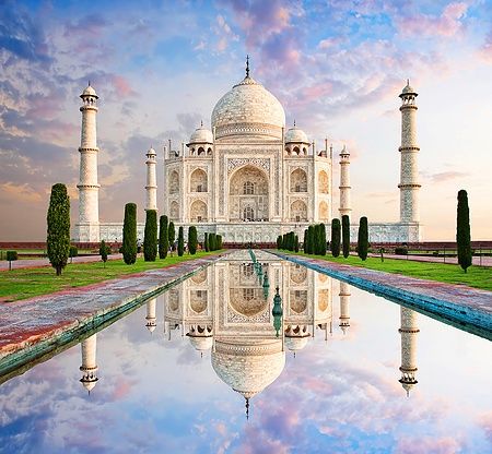 Taj Mahal ad Agra al tramonto con riflesso nell'acqua.
