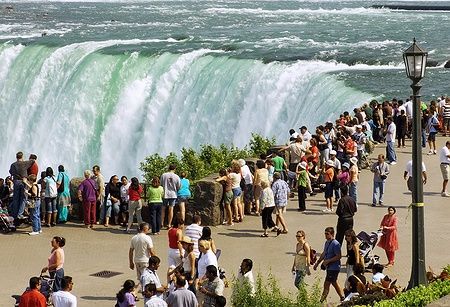 Folla di turisti osserva le cascate del Niagara dal lato canadese.