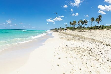 Spiaggia bianca di Playa del Este a L'Avana, Cuba, con mare turchese e cielo azzurro.
