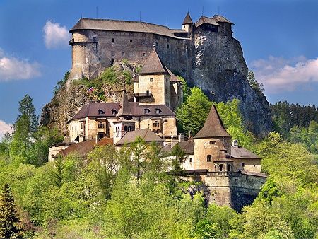 Orava Castle in Slovacchia su una scogliera circondato da foreste verdi.