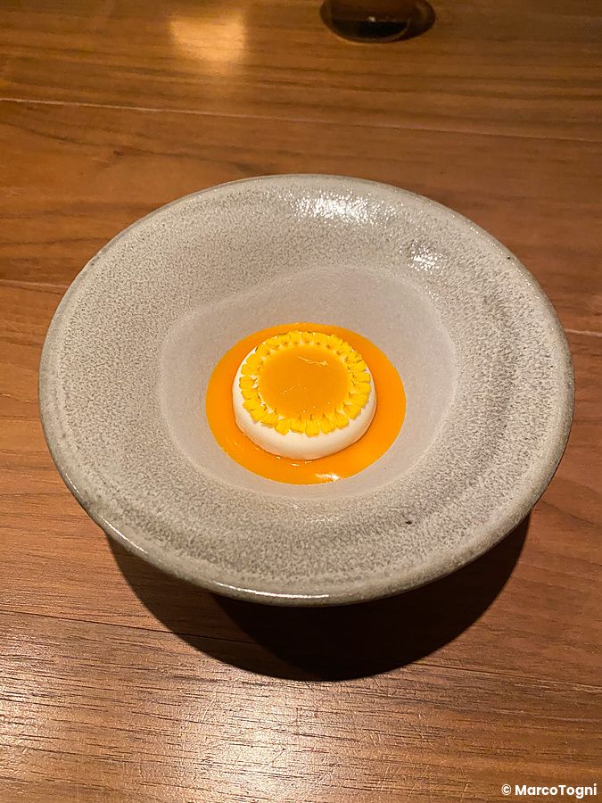 Un raffinato dolce al formaggio servito in una ciotola di ceramica nel Ristorante Crony, Tokyo.