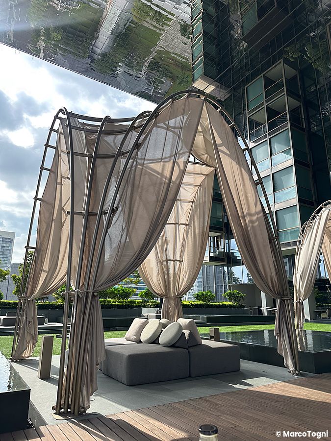 Zona esterna dell'executive lounge al Pan Pacific Orchard con eleganti tende e divano.