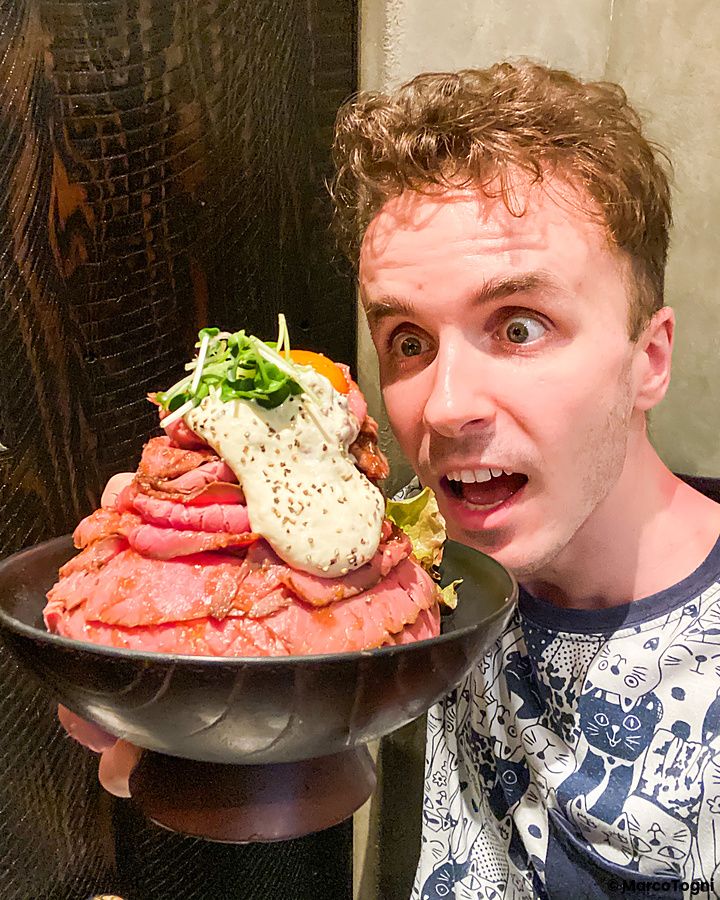 Marco Togni mostra una grande ciotola di donburi con roast beef presso il ristorante Red Rock.