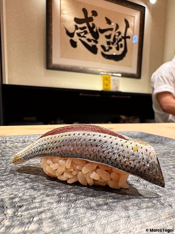 Un nigiri di kohada adagiato su un piatto in pietra presso il ristorante Sushi Punch a Tokyo.
