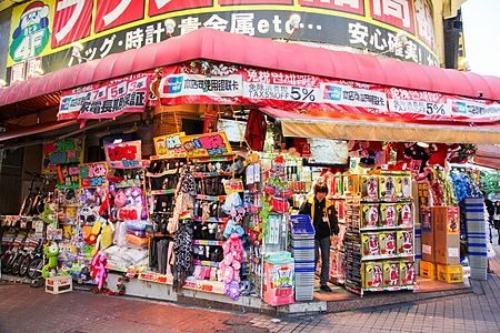 L'ingresso affollato di articoli del negozio Don Quijote a Kabukicho, Shinjuku, con una persona che entra.