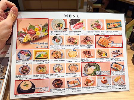 Menu illustrato del Ristorante New Sushi Center Harukiya a Osaka con immagini di varie pietanze di pesce.