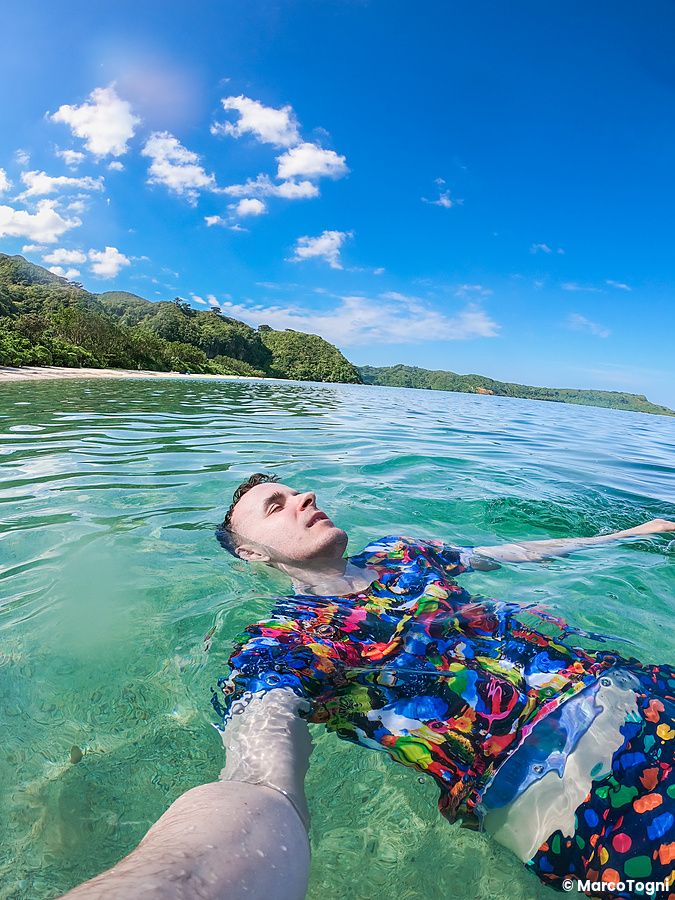 Marco Togni galleggia nell'acqua cristallina sulla spiaggia di Ida a Iriomote, Okinawa.