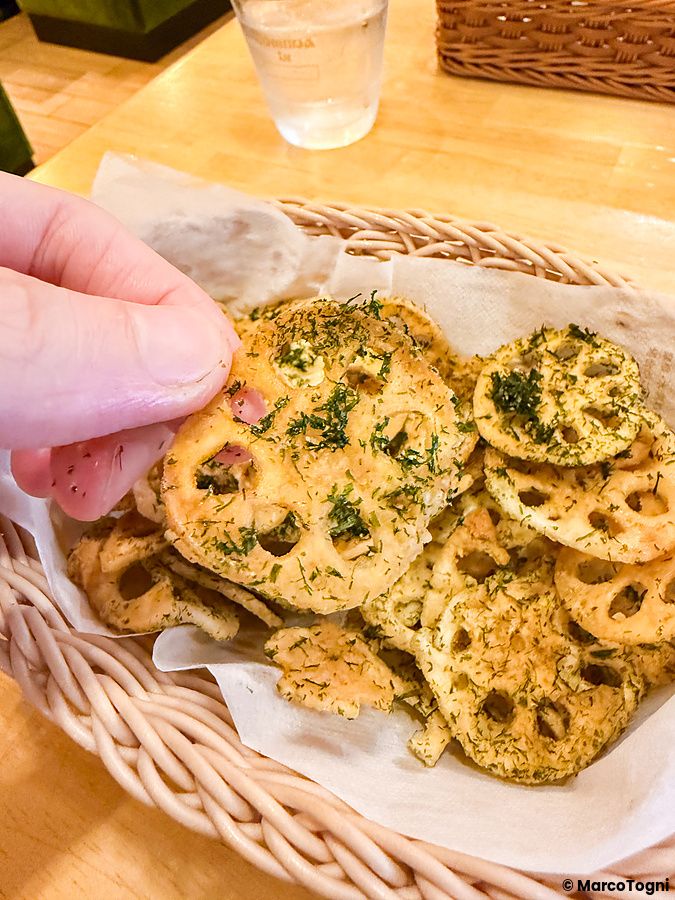 Cesto di radici di loto fritte al Komeda Is, cosparse di erbe e spezie.