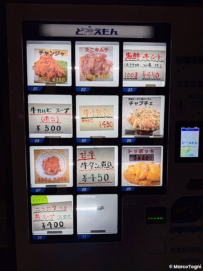 Una macchina distributrice giappone in Giappone che vende piatti pronti surgelati con etichette e prezzi in yen.