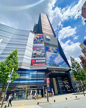Edificio moderno con cinema e manifesti pubblicitari a Shinjuku, Tokyo.