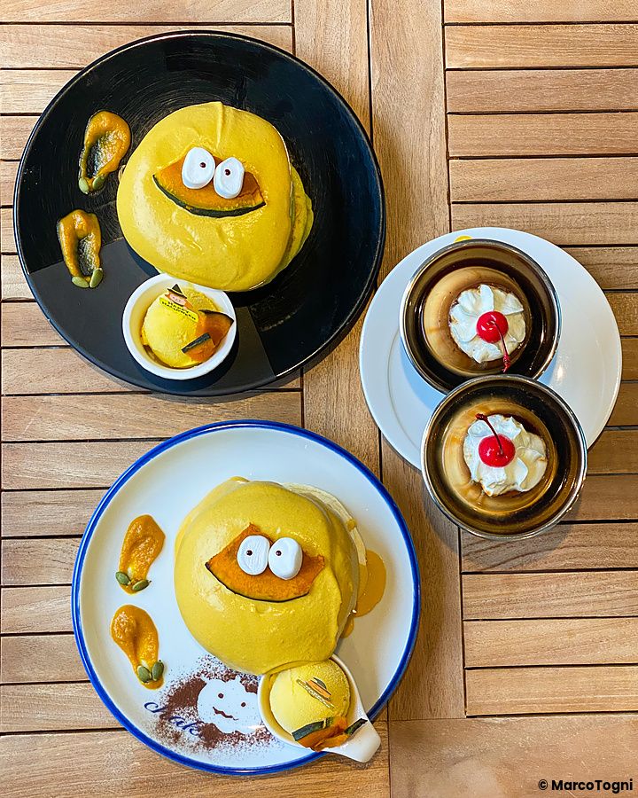 Pancake alla zucca a tema Halloween su piatti colorati.