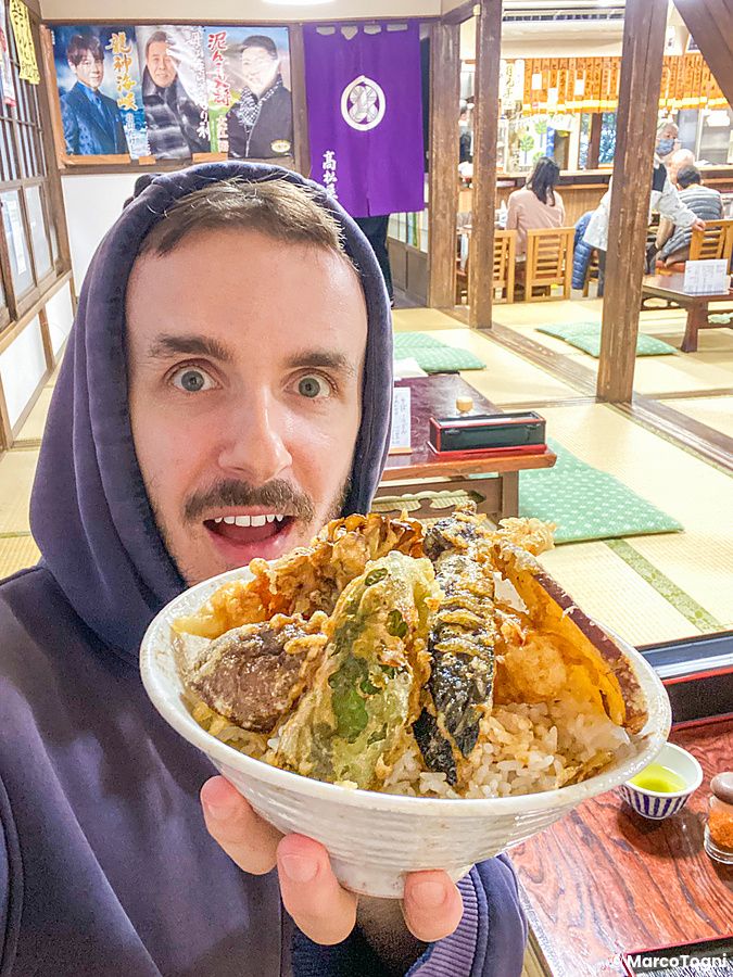 Marco Togni tiene una ciotola di tempura udon in un ristorante tradizionale con pavimenti in tatami.