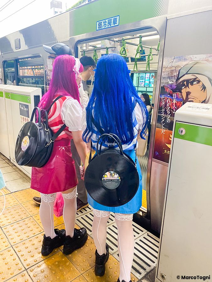 Due individui in cosplay attendono di prendere un treno a Tokyo.