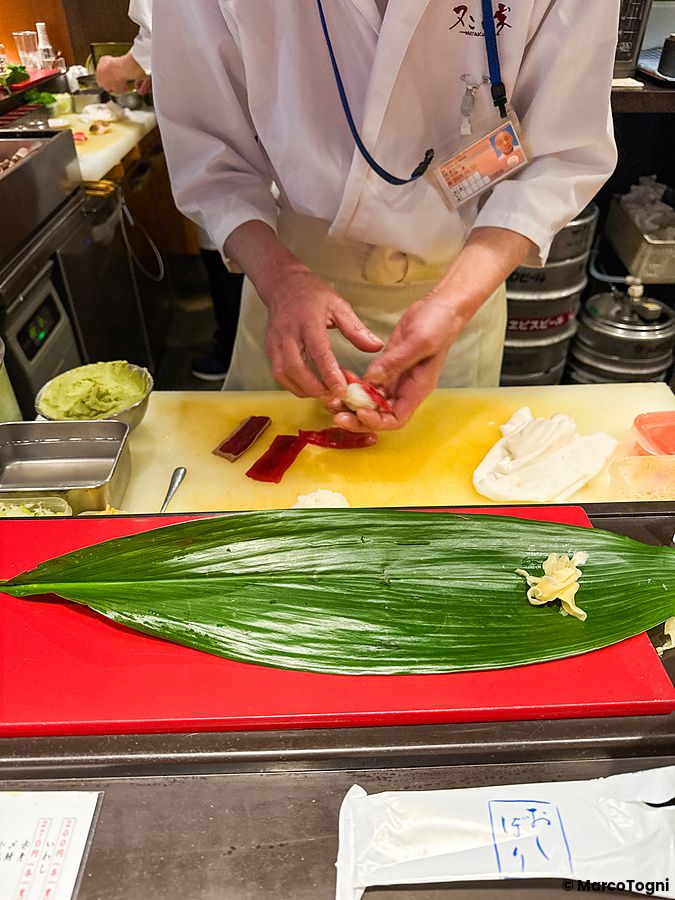 Uno chef prepara del sushi al ristorante Matakoiya presso l'aeroporto di Haneda.