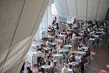 Persone sedute in una caffetteria all'interno di The National Art Center a Tokyo.