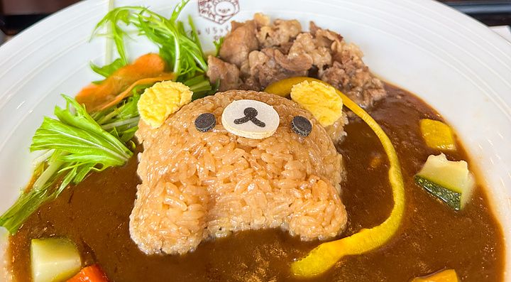Un piatto di curry con riso a forma di orso alla Rilakkuma Tea House ad Arashiyama, con tre pupazzi sullo sfondo.