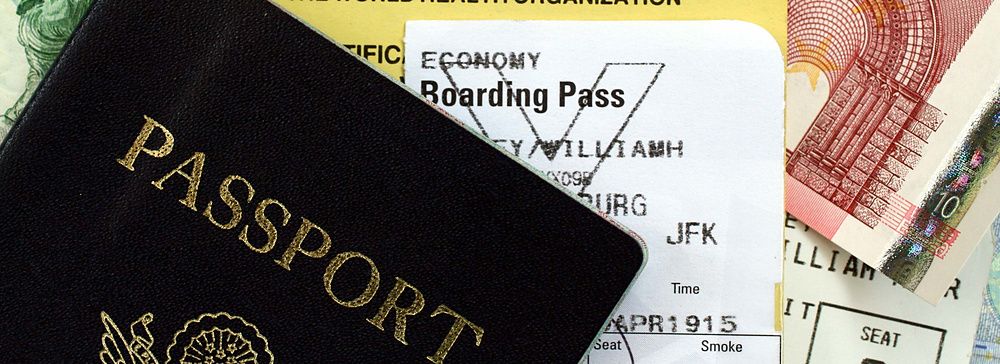 Passaporto con certificato di vaccinazione, carta telefonica e valuta.