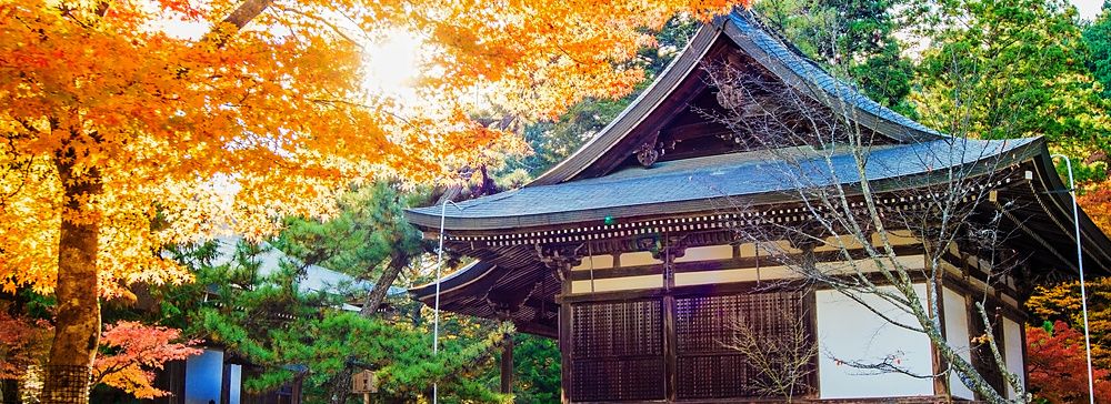 Tempio Jingo-ji a Kyoto circondato da foglie autunnali colorate.