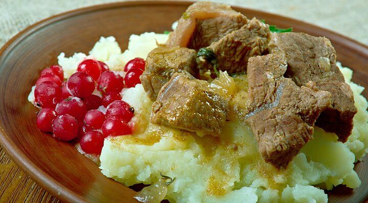 Piatto norvegese con carne, purè di patate e mirtilli rossi.