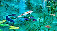 Stagno con ninfee e carpe, ispirato alle opere di Monet.