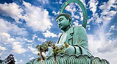 La statua del Daibutsu di Takaoka sotto un cielo nuvoloso.