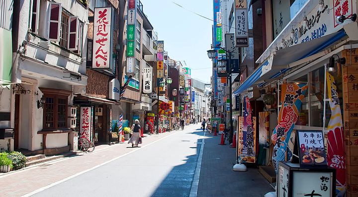 Strada commerciale a Kichijoji con edifici e cartelli colorati.