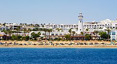 Spiaggia e hotel di Sharm El Sheikh con mare in primo piano.
