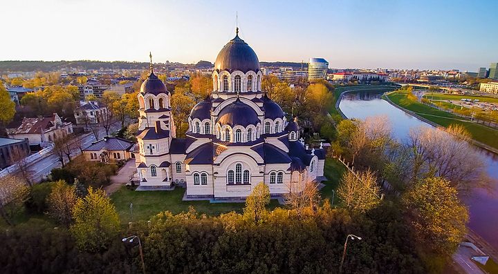 Chiesa ortodossa a Vilnius con fiume e città sullo sfondo.