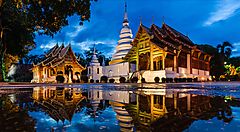 Tempio tradizionale riflesso nell'acqua a Chiang Mai al tramonto.