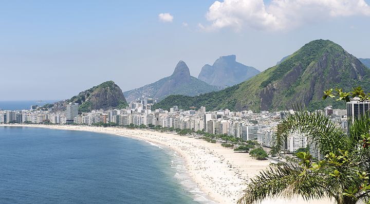 Spiaggia di Copacabana a Rio de Janeiro con montagne sullo sfondo.