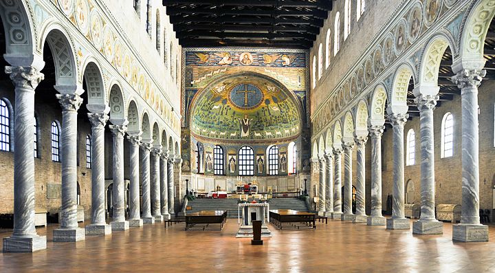 Interno di una basilica a Ravenna con colonne e mosaici brillanti.