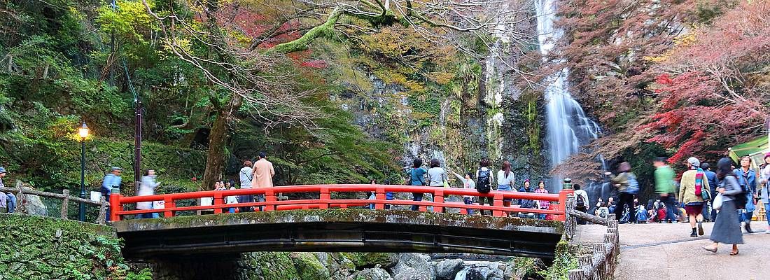 Ponte rosso al Parco Minoo, nei pressi di una cascata.