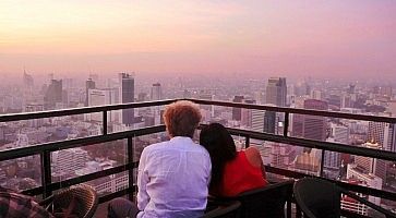 Una coppia ammira Bangkok dall'alto al tramonto.