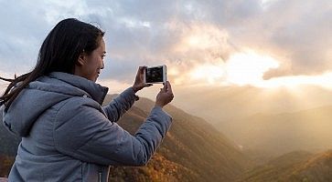 Woman taking photo on mountain