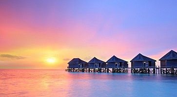 Sunset on Maldives island, water villas resort