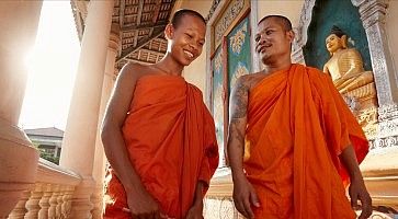 Two monks meet and salute in a buddhist monastery, Asia