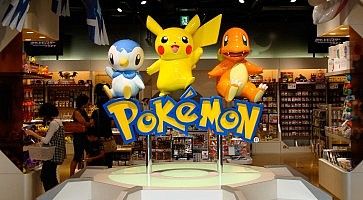 Dettaglio di un negozio Pokemon Center, con il logo e vari personaggi.